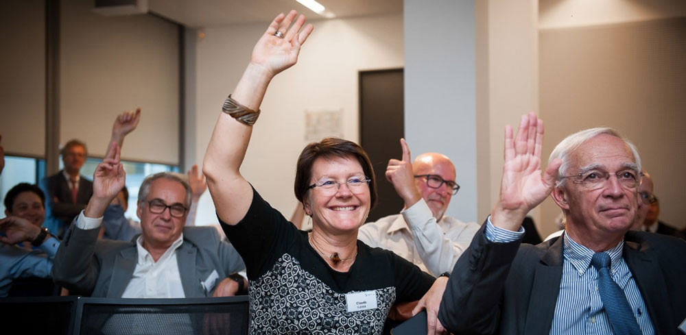 Audience hands up during the final discussion on the future for CO2 capture from cement.