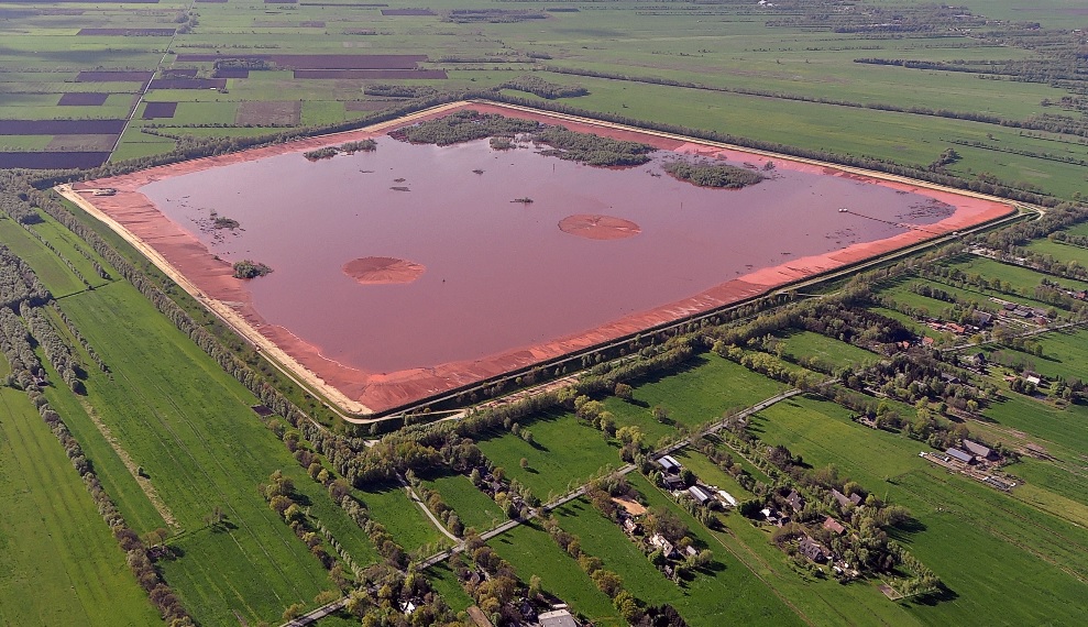 Bauxite residue By Wikipedia-User: Ra Boe - https://commons.wikimedia.org/wiki/File:Luftaufnahmen_Nordseekueste_2012-05-by-RaBoe-478.jpg, CC BY-SA 3.0, https://commons.wikimedia.org/w/index.php?curid=51380859