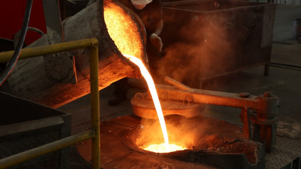Molten iron poured into furnace during casting process