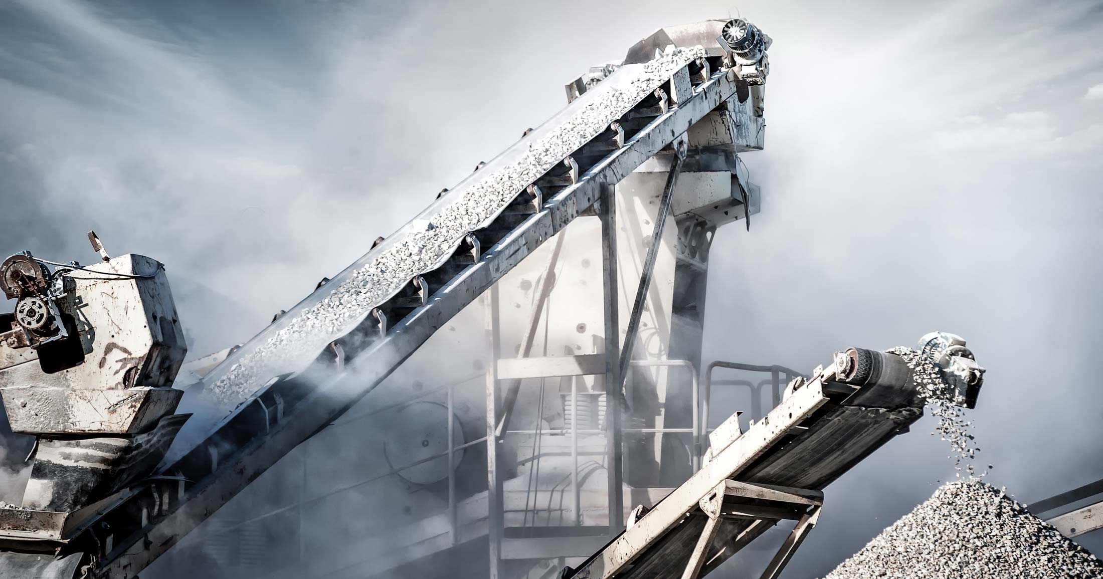 Cement production factory on mining quarry. Conveyor belt of heavy machinery loads stones and gravel