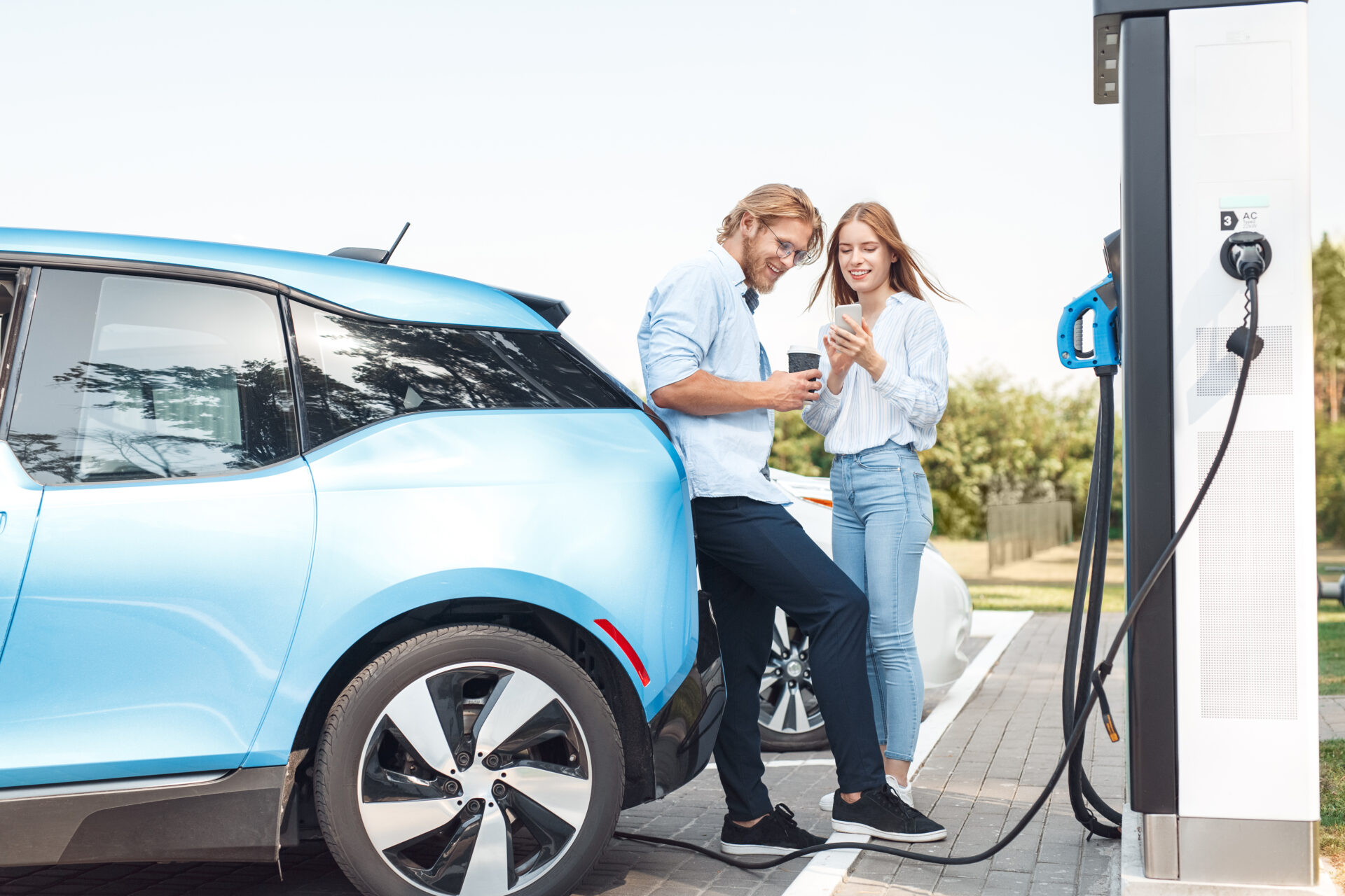 couple charging an electric car