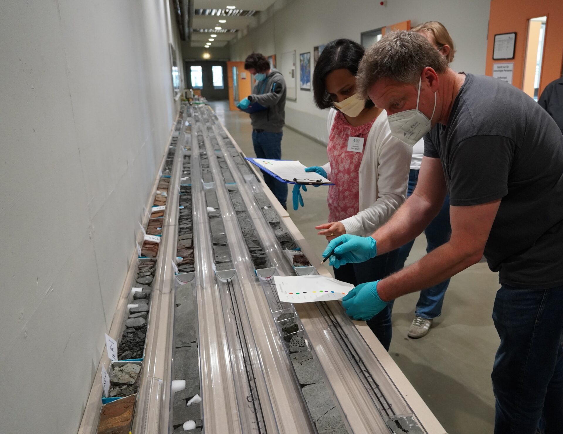 Christian Berndt (right; GEOMAR) and Sayantani Chatterjee (centre; Niigata University) going through the sample requests and marking the desired intervals.