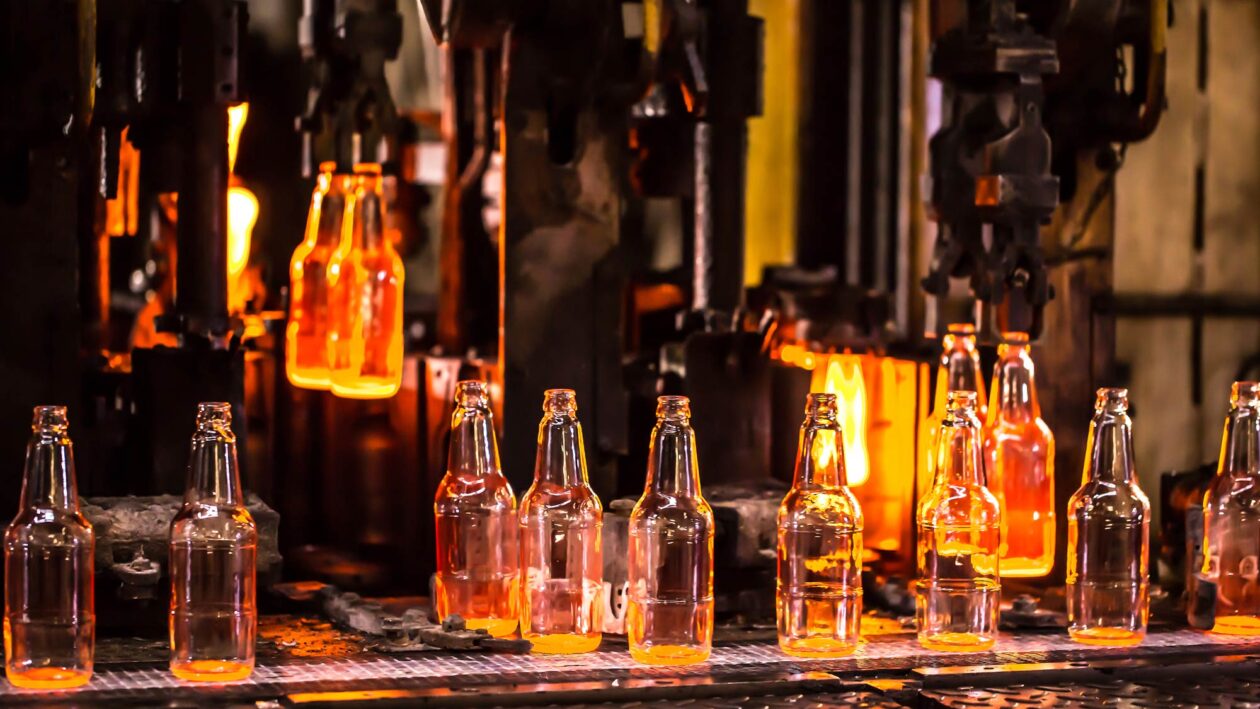 Glass bottles being manufactured in a furnace.