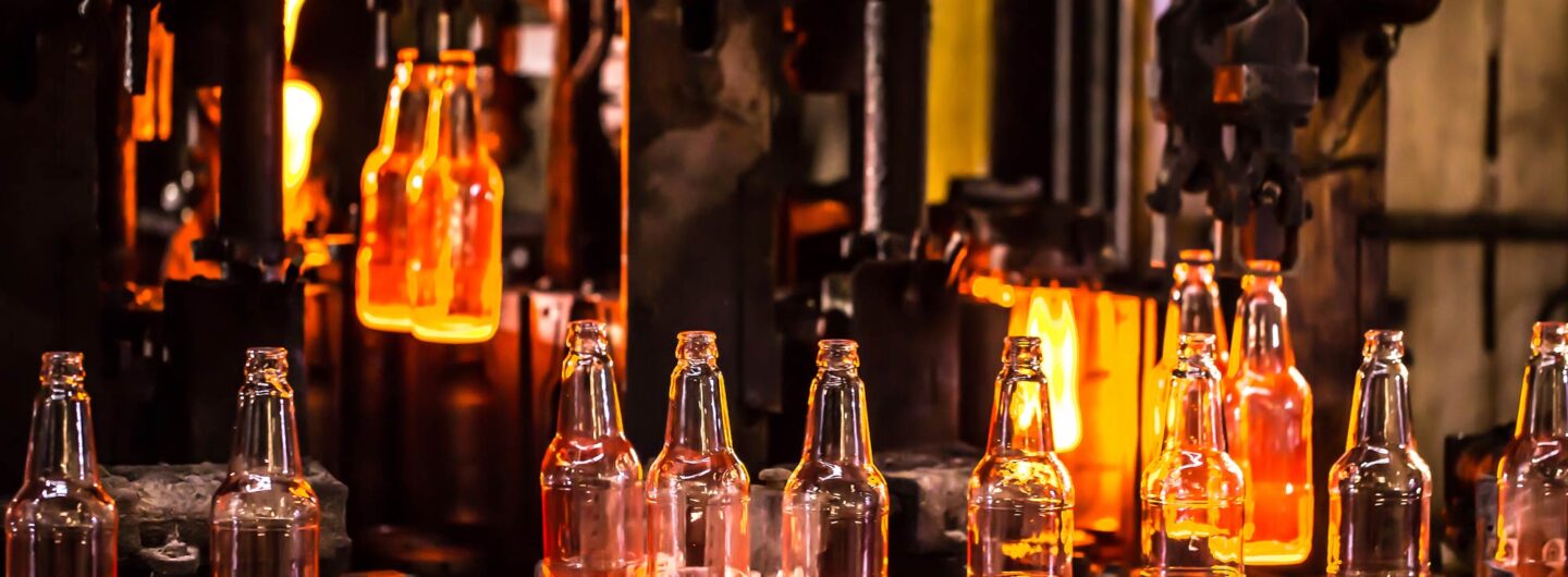 Glass bottles being manufactured in a furnace.