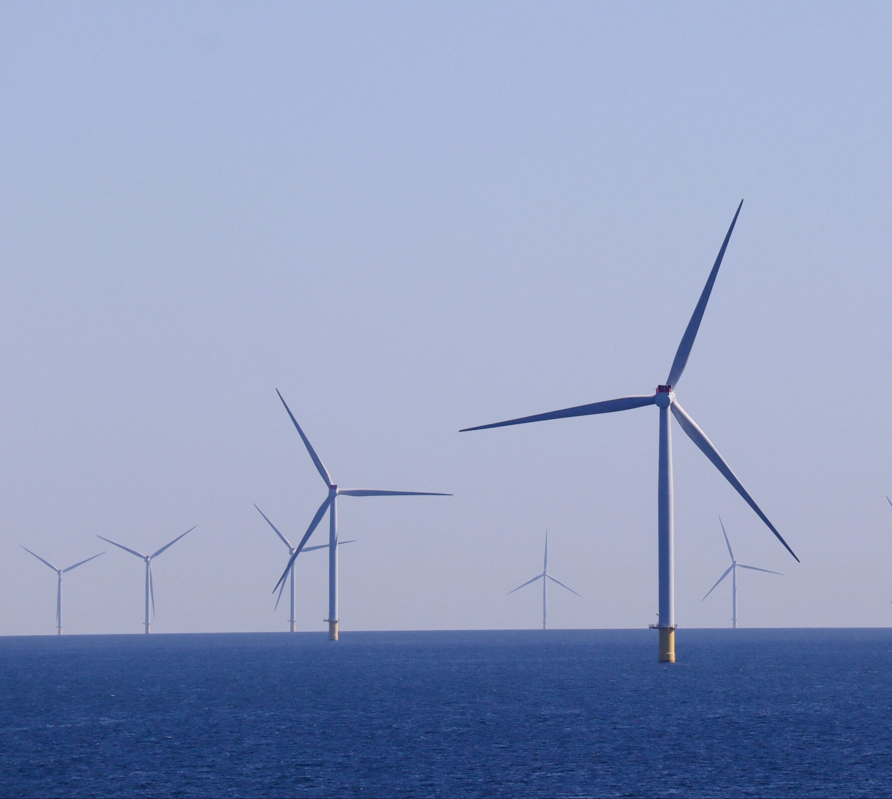 Photo by Damir.: https://www.pexels.com/photo/wind-turbines-on-the-sea-13223602/