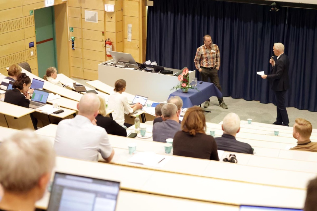 A room full of people attending a conference.