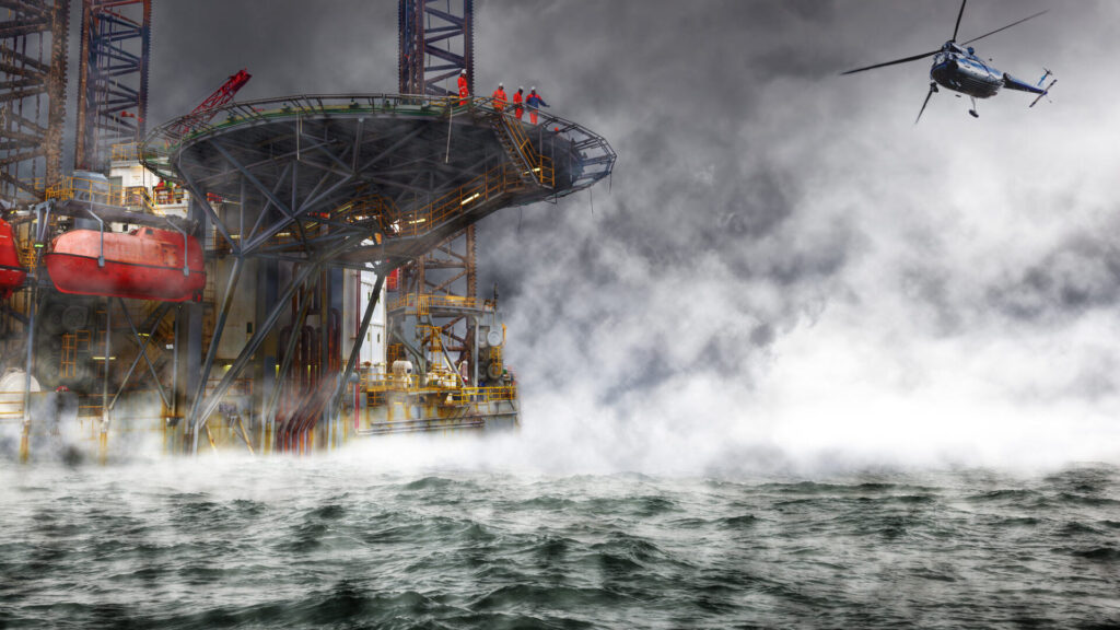 A helicopter approaching an offshore oil platform during a storm.