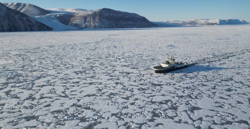 FF Kronprins Haakon sailing in Greenland’s largely untouched Independence Fjord, with a glacier in the background.