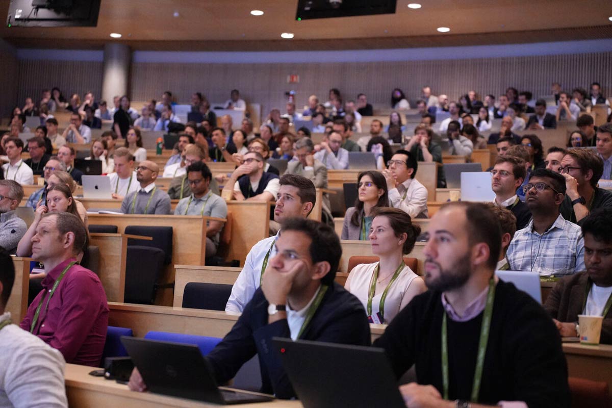 Conference attendees in an auditorium.