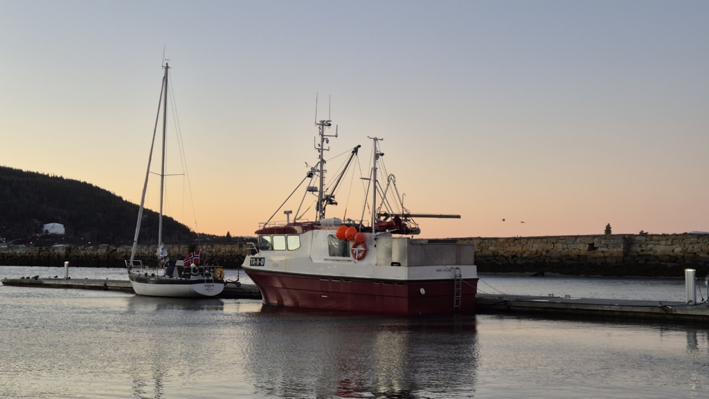 Fishing boat in sunset.